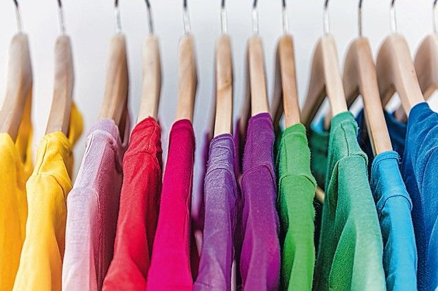 Fashion_clothes_on_clothing_rack_-_bright_colorful_closet._Closeup_of_rainbow_color_choice_of_trendy_female_wear_on_hangers_in_store_closet_or_spring_cleaning_concept._Summer_home_wardrobe.