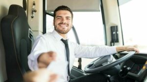 Smiling_Latin_driver_taking_ticket_from_passenger_for_bus_ride