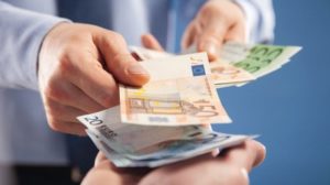 Businessman's__hands_exchanging_euro_on_blue_background,_closeup_shot