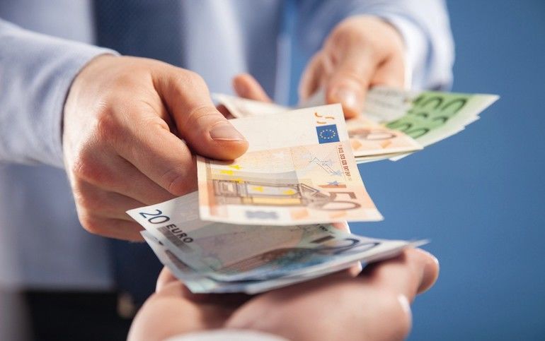 Businessman's__hands_exchanging_euro_on_blue_background,_closeup_shot