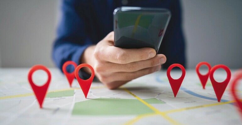 Person_Using_Map_With_Red_Location_Markers_On_Mobile_Phone