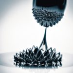 Macro_photograph_of_Ferrofluid_flowing_from_one_magnet_to_another._Ferrofluid_is_a_colloidal_liquid_of_nanoscale_particles_in_a_carrier_fluid_that_becomes_magnetized_by_approaching_a_magnet.
