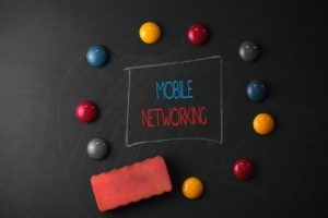 Conceptual_hand_writing_showing_Mobile_Networking._Concept_meaning_Communication_network_where_the_last_link_is_wireless_Round_Flat_shape_stones_with_same_sizes_stick_black_board