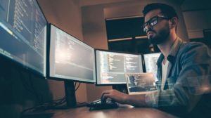 Profile_side_view_of_nice_attractive_serious_skilled_qualified_smart_clever_bearded_brunet_guy_nerd_building_fixing_extracting_file_editing,_framework_web_design_in_dark_beige_room_workplace_station