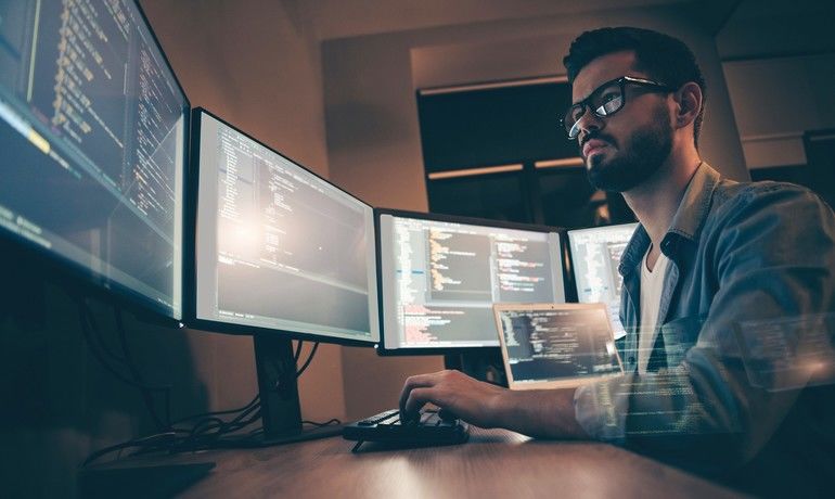 Profile_side_view_of_nice_attractive_serious_skilled_qualified_smart_clever_bearded_brunet_guy_nerd_building_fixing_extracting_file_editing,_framework_web_design_in_dark_beige_room_workplace_station