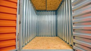 Interior_of_an_open_empty_large_rectangular_container_made_of_corrugated_steel_walls_and_wood_flooring