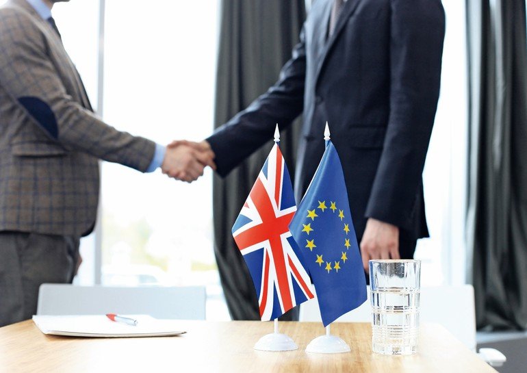 European_Union_and_United_Kingdom_leaders_shaking_hands_on_a_deal_agreement._Brexit